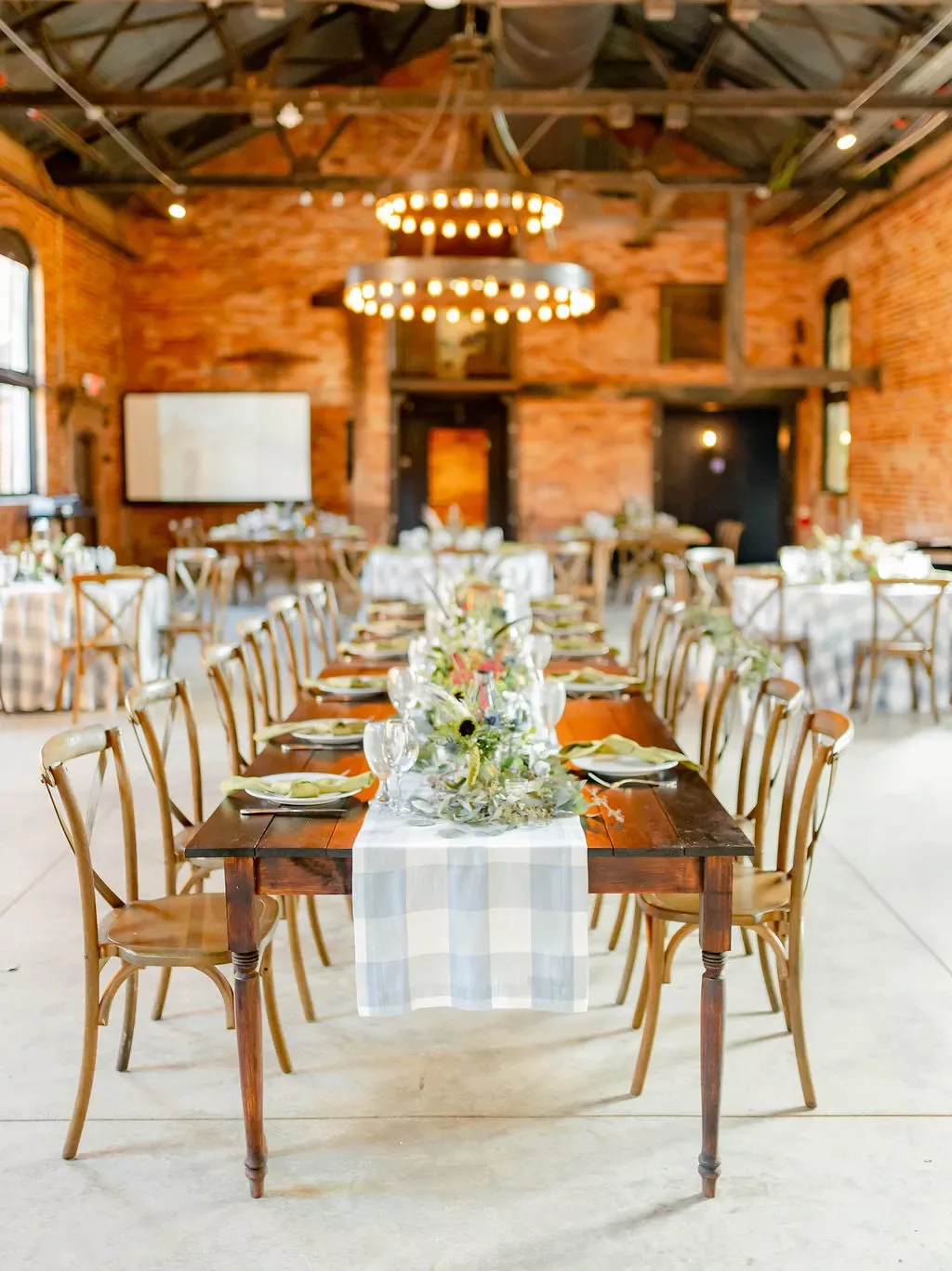 Elegant rustic long dining table set for a wedding reception