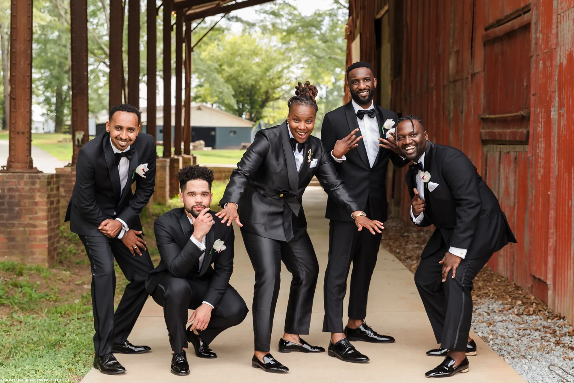 Groomsmen posing for a funny photo during wedding portraits at Empire Mills in Madison, Georgia