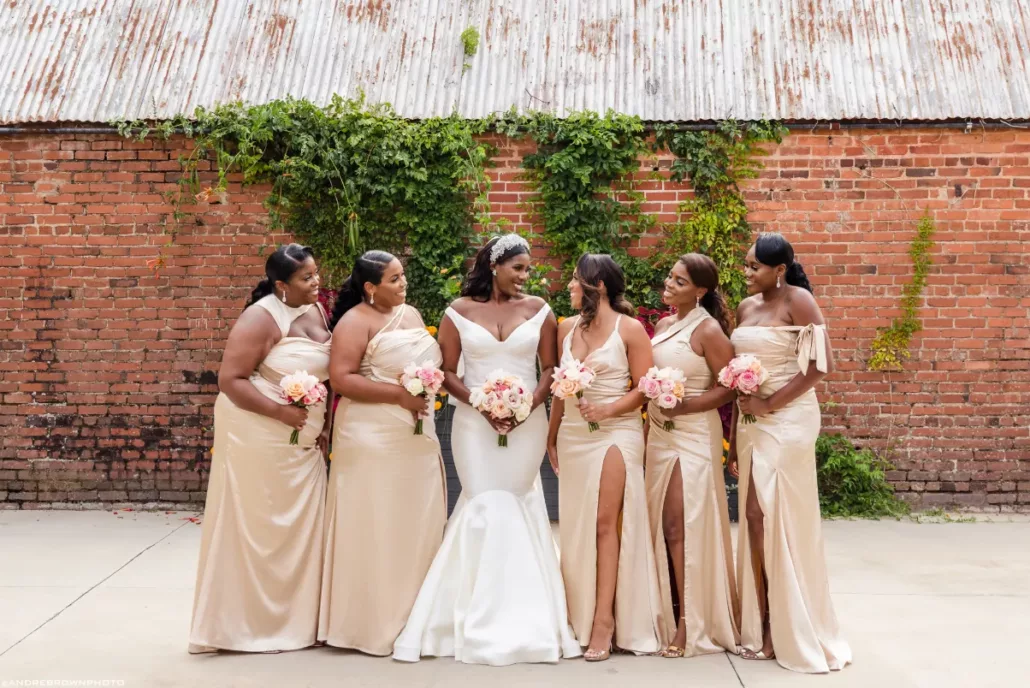 5 summer wedding empire mills Bride and bridesmaids holding bouquets posing for wedding portraits in rustic Georgia setting