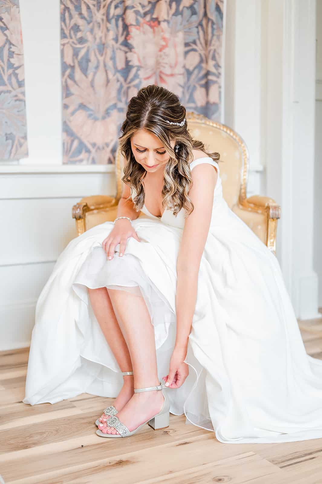 Hatfield Creswell Wedding Wedding guests embracing at a reception on a loveseat in a nook room designed to be elegant and rustic