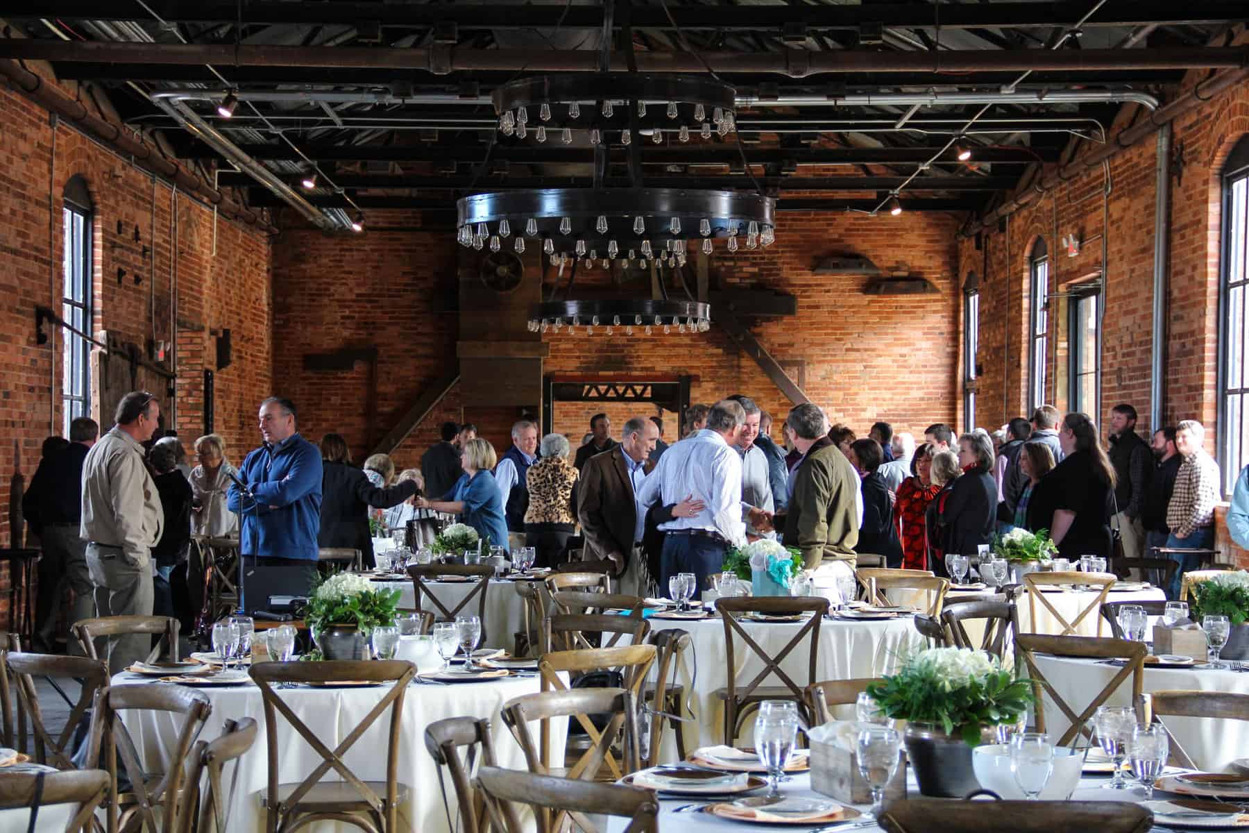 People gathering inside grande hall at Empire Mills in Madison, Georgia.