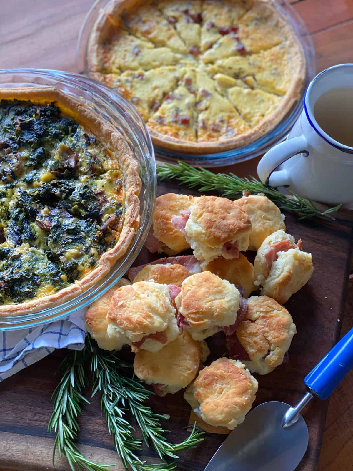 An assortment of food including ham biscuits and breakfast quiches